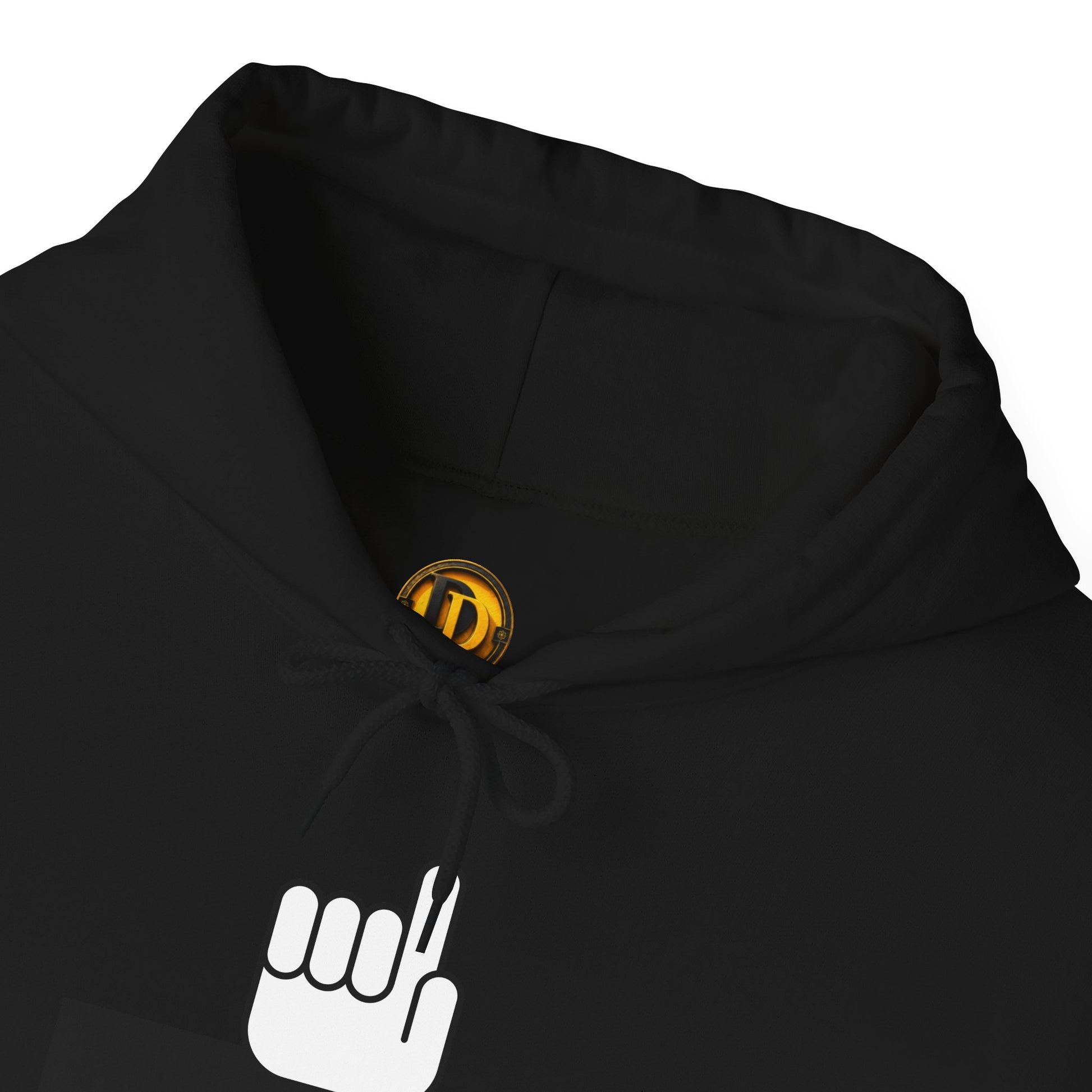 Close-up of a black hoodie showing the inner neck area with a small circular gold and black logo patch and a white hand graphic printed on the chest.