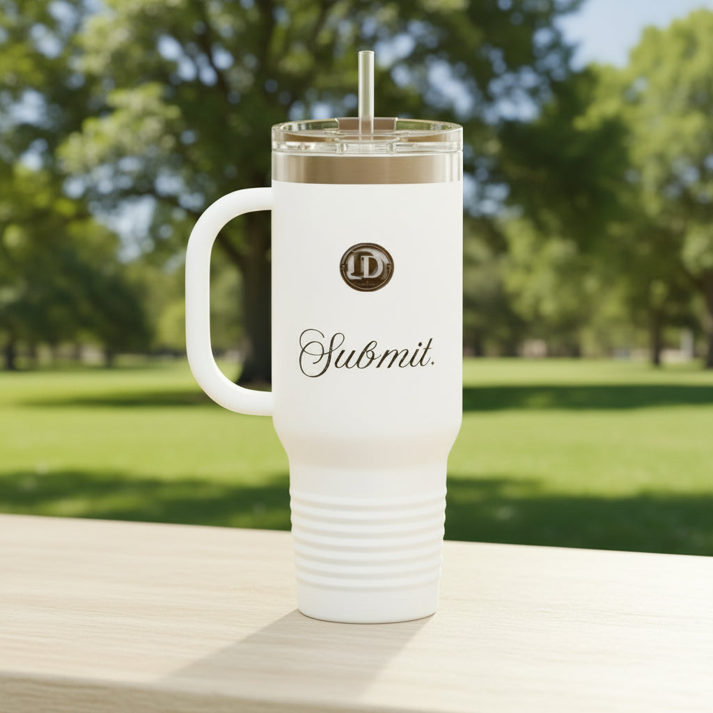 An ice white insulated travel tumbler with a handle, clear lid, and straw, featuring a circular 'ID' logo and the word 'Submit.' in black script on the front, shown at the park. Muslim islam faith stanley cup premium niche custom made
